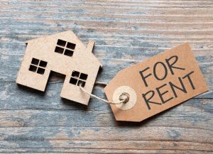 Wooden cut out house with for rent label