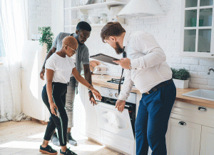 Couple being shown round rental property by estate agent