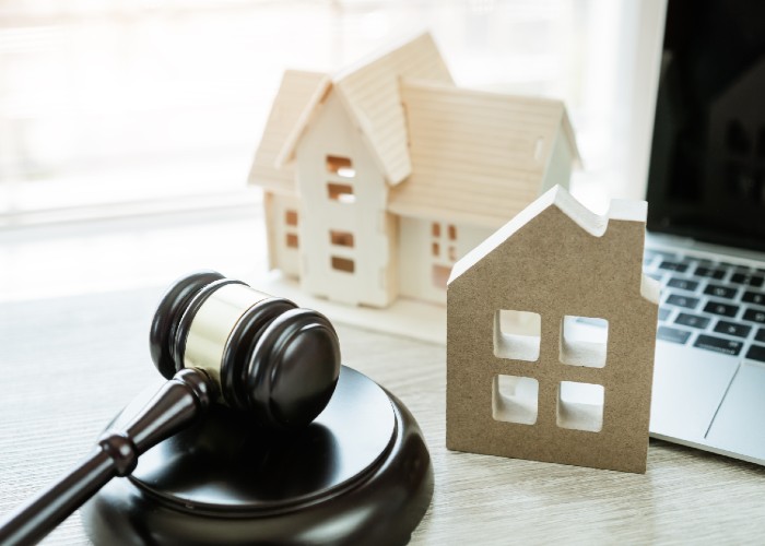 auction gavel by model of house
