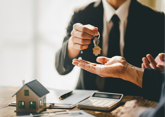 man handing over keys to rental house