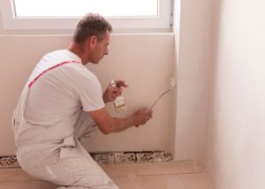 man deorating a room of a house