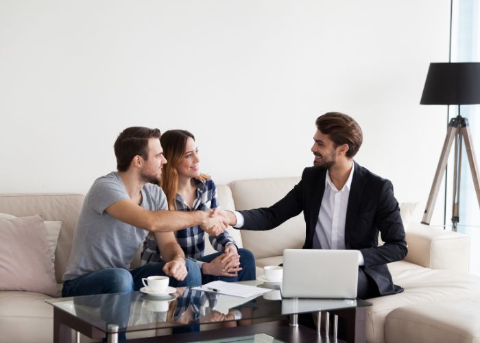 Agent showing couple around at property